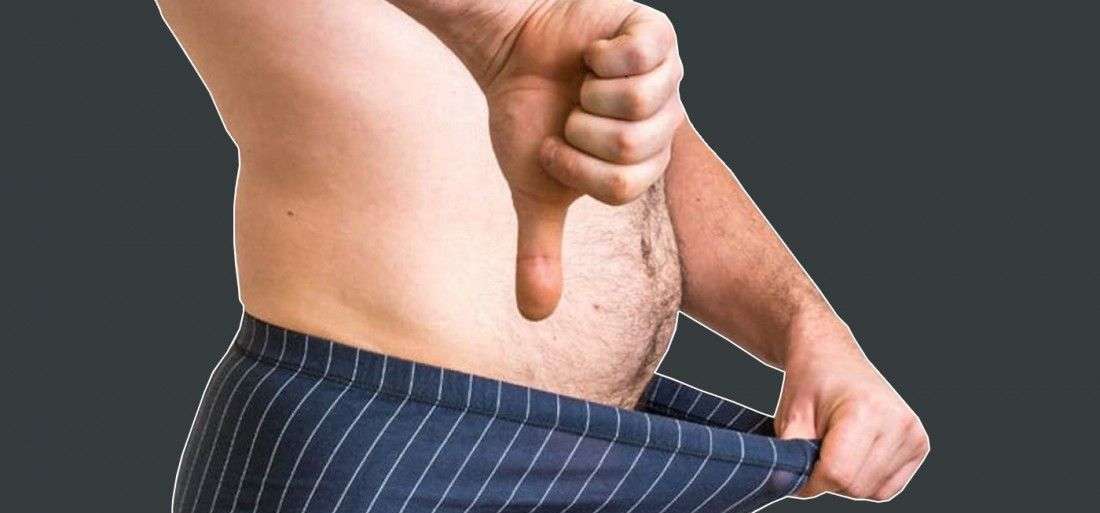 shirtless man doing thumbs down sign